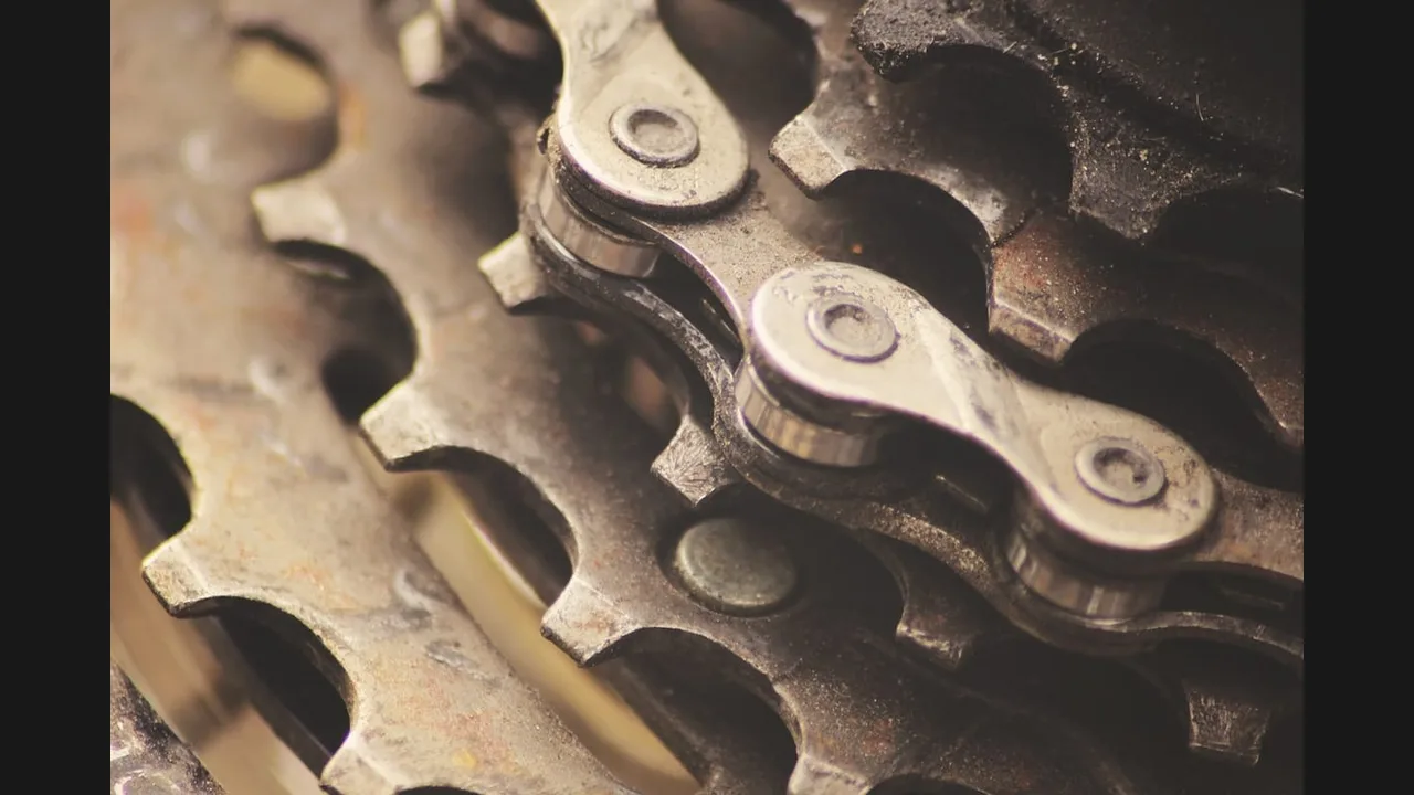 Close-up photograph of a bicycle chain wrapped around its gears