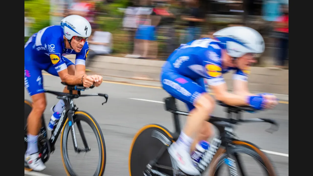 Two racing cyclists sprinting side by side on a road